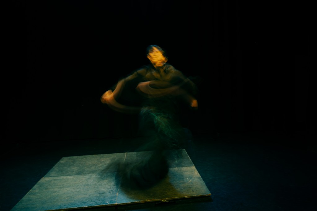 a woman during dance performance captured in long exposure